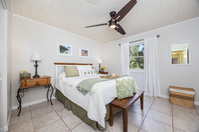 tiled bedroom featuring ceiling fan and crown molding