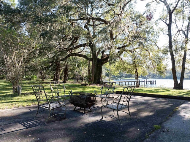 surrounding community with an outdoor fire pit, a patio, and a yard