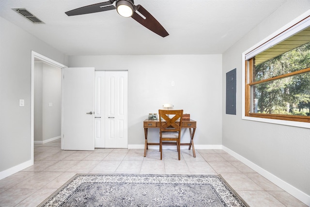 home office with ceiling fan, electric panel, and light tile patterned flooring