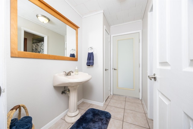 bathroom with ornamental molding and tile patterned flooring