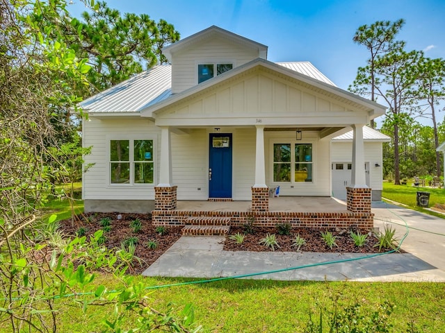 view of front of property with covered porch and a front yard