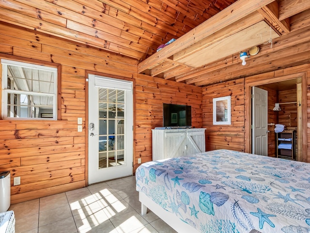 bedroom with light tile patterned flooring, wood ceiling, and wooden walls