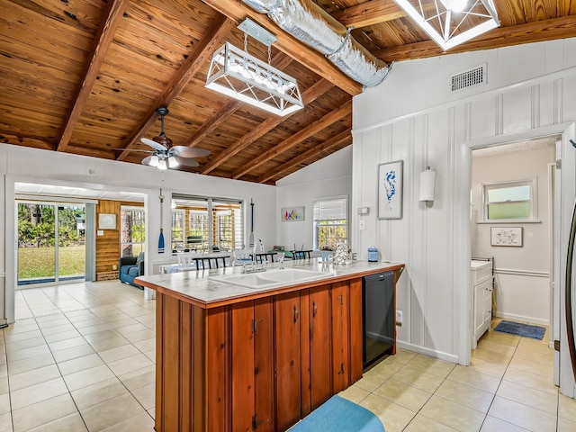 kitchen with dishwasher, sink, light tile patterned floors, and kitchen peninsula