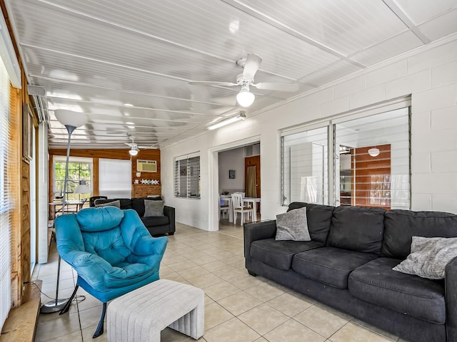 living room featuring light tile patterned flooring, ceiling fan, and a wall unit AC