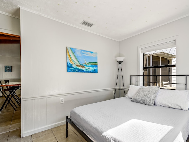 bedroom featuring light tile patterned flooring and ornamental molding