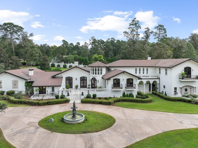 mediterranean / spanish house featuring a front lawn