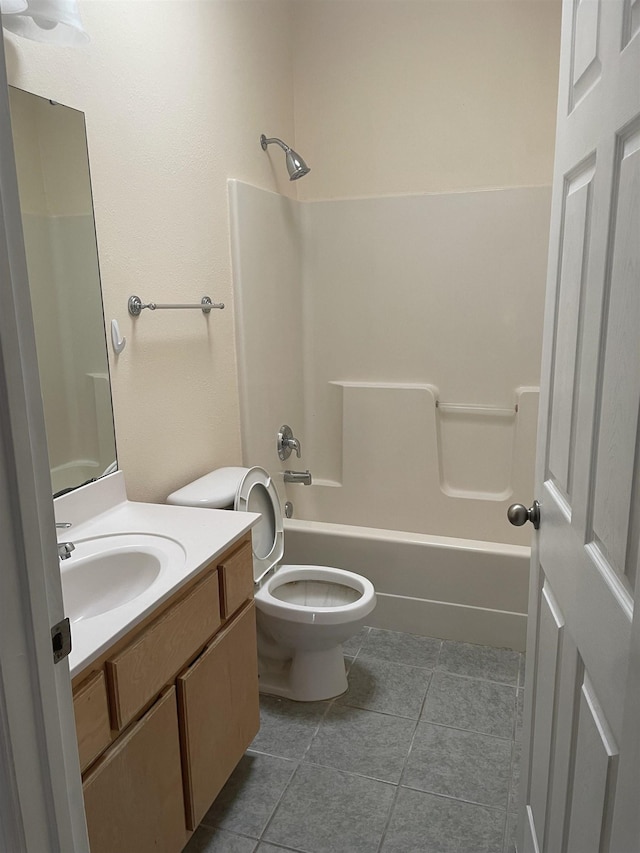 full bathroom with tile patterned flooring, vanity,  shower combination, and toilet