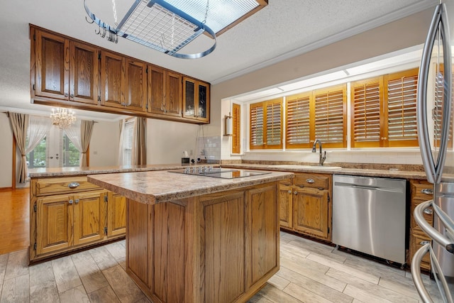 414 Tharpe Cir, Quincy, FL 32351 - kitchen with stainless steel appliances, a kitchen island, a sink, a chandelier, and brown cabinets
