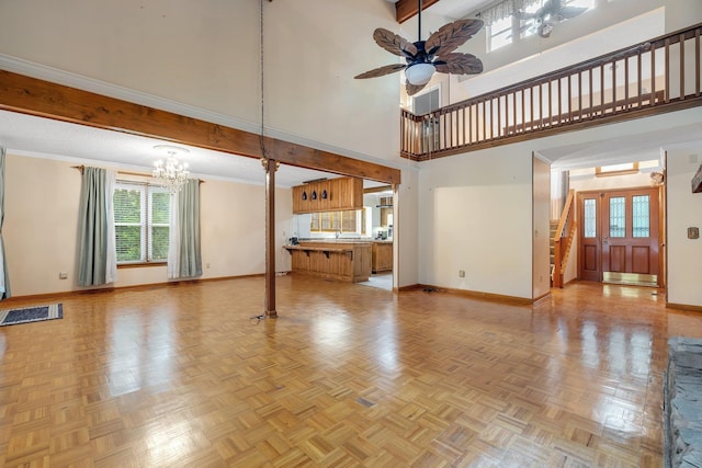 414 Tharpe Cir, Quincy, FL 32351 - unfurnished living room featuring baseboards, a chandelier, a towering ceiling, ceiling fan, and stairs