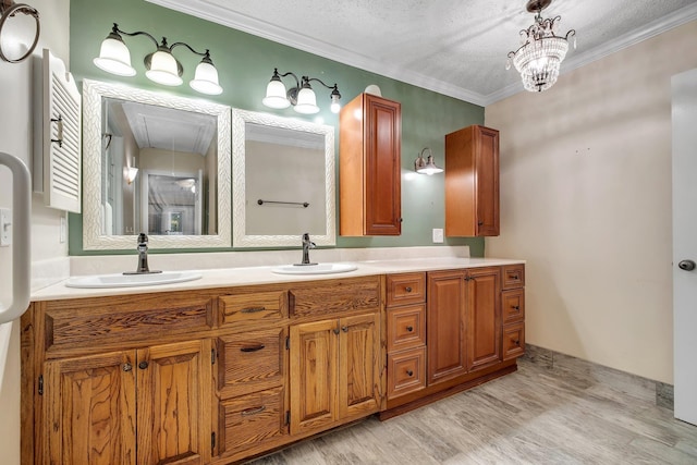 414 Tharpe Cir, Quincy, FL 32351 - full bath featuring wood finished floors, double vanity, ornamental molding, and a textured ceiling
