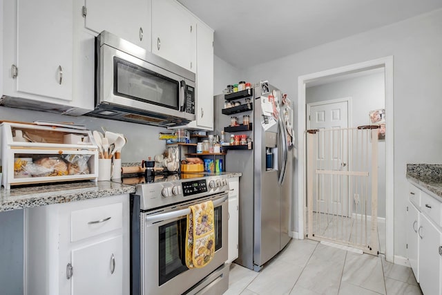 2401 Lanrell Dr, Tallahassee, FL 32303 - kitchen with stainless steel appliances, white cabinetry, and light stone counters