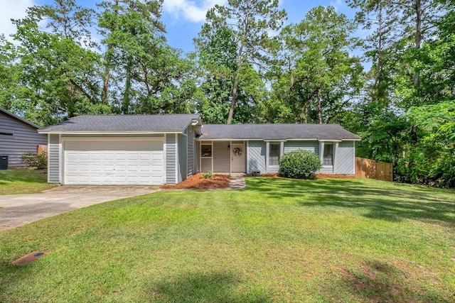 2401 Lanrell Dr, Tallahassee, FL 32303 - view of front facade with a garage, driveway, and central AC unit
