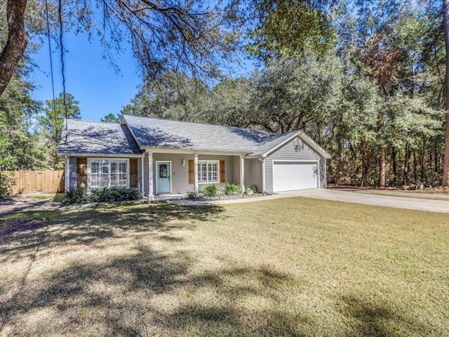 ranch-style house featuring a front yard and a garage