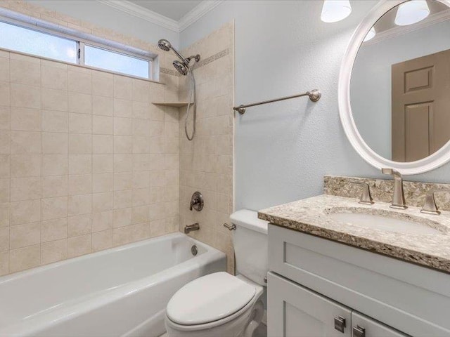 full bathroom with tiled shower / bath combo, crown molding, vanity, and toilet