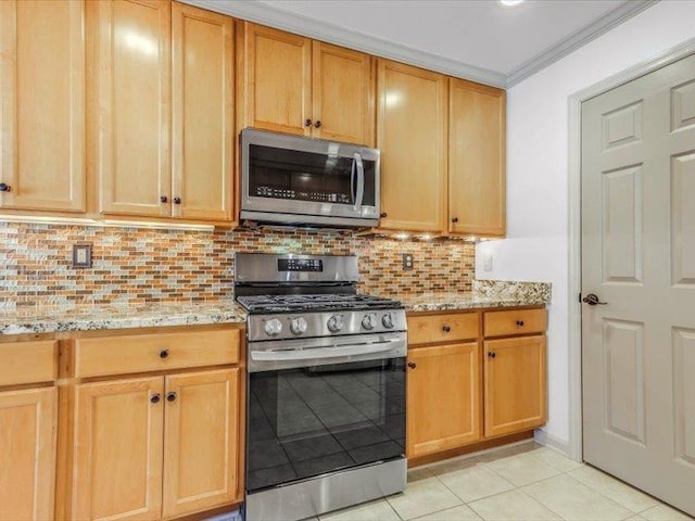 kitchen with tasteful backsplash, light stone counters, appliances with stainless steel finishes, crown molding, and light tile patterned flooring