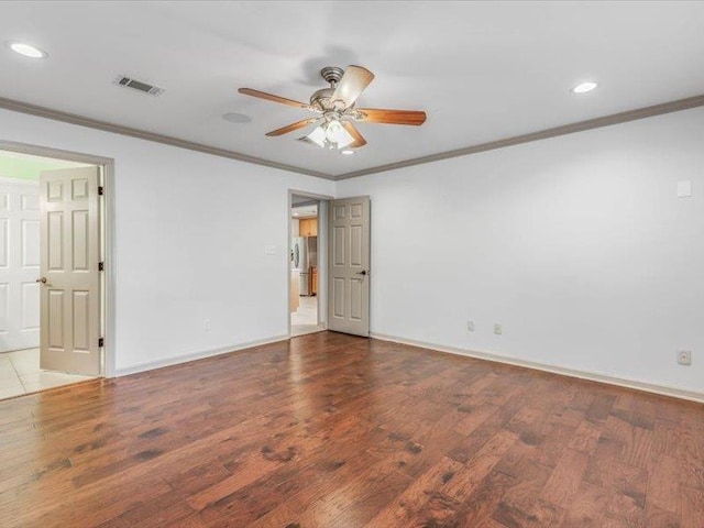 unfurnished room featuring ornamental molding, ceiling fan, and hardwood / wood-style floors