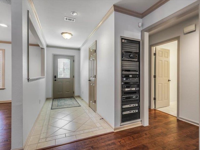 foyer featuring hardwood / wood-style floors and crown molding