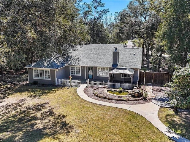 rear view of property with a yard