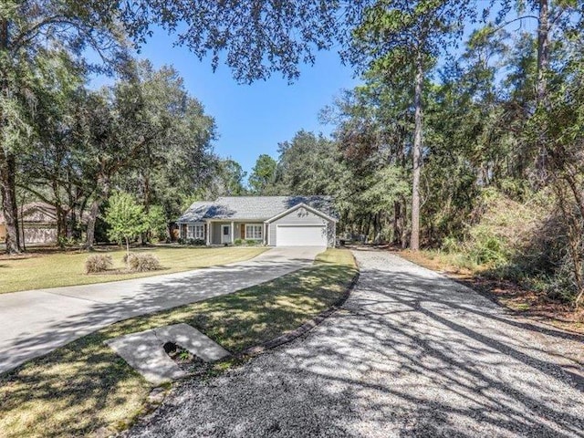 view of front of property featuring a front lawn and a garage