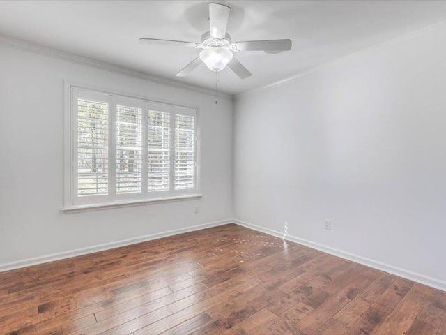 spare room featuring ceiling fan, ornamental molding, and dark wood-type flooring