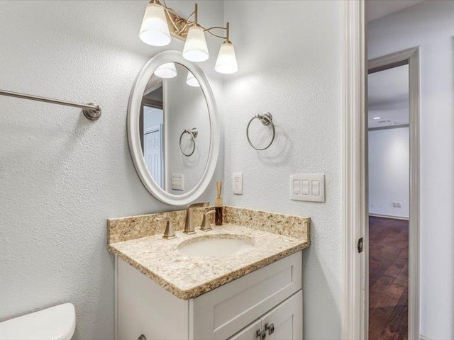 bathroom featuring toilet and vanity