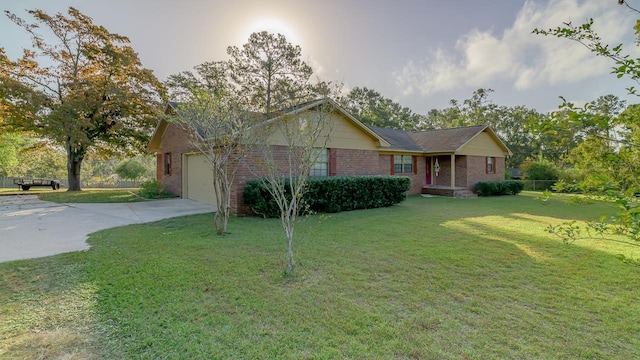 ranch-style house featuring a front lawn and a garage