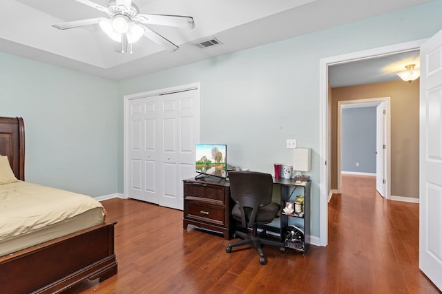 bedroom with ceiling fan, a closet, and dark hardwood / wood-style flooring