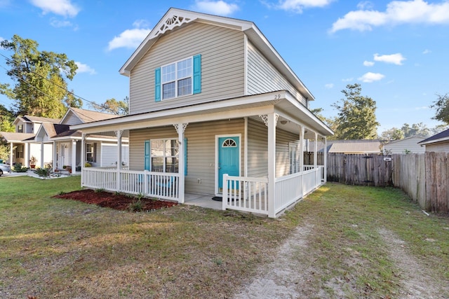 farmhouse inspired home with a front yard and covered porch