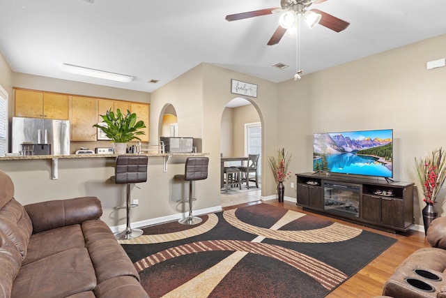 living room featuring light wood-type flooring and ceiling fan