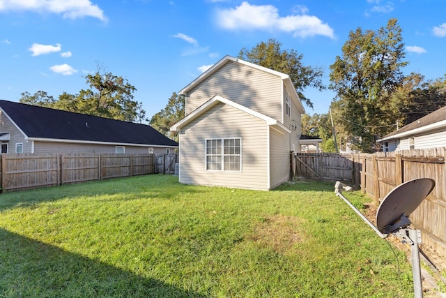 rear view of house featuring a lawn