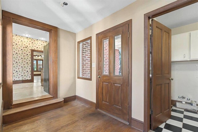 entryway featuring baseboards and wood finished floors