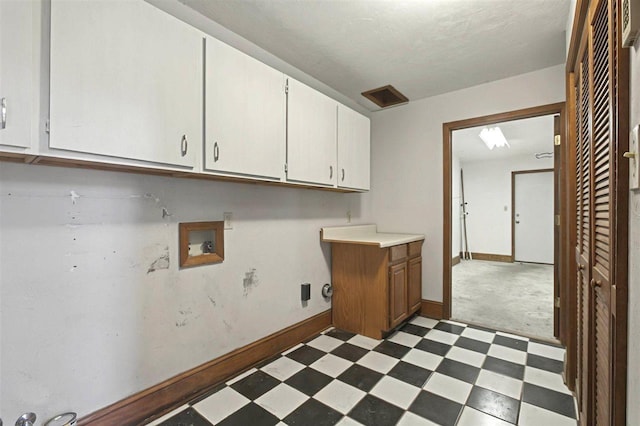clothes washing area with baseboards, cabinet space, tile patterned floors, and hookup for a washing machine