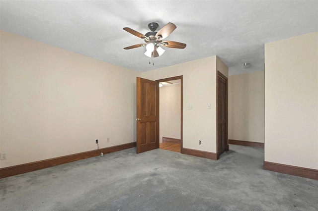 carpeted empty room with baseboards and ceiling fan
