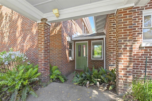 property entrance featuring brick siding