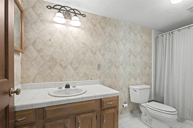 bathroom featuring toilet, vanity, tile patterned floors, and visible vents