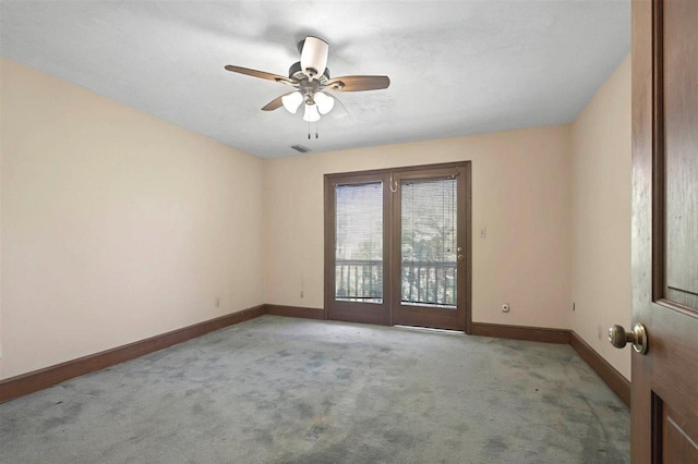 unfurnished room featuring baseboards, ceiling fan, visible vents, and light colored carpet