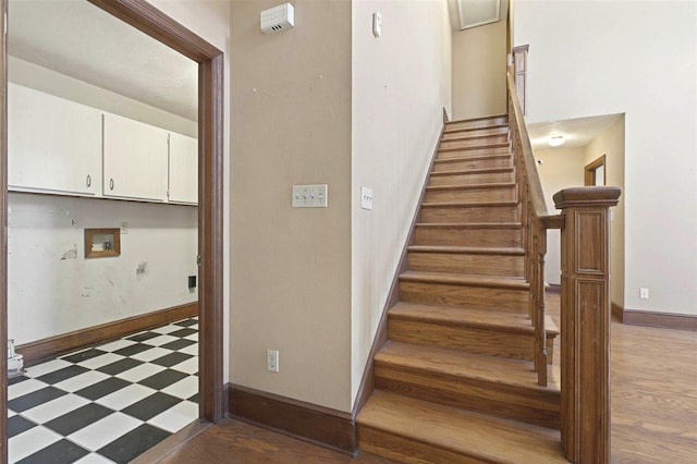 staircase featuring tile patterned floors and baseboards