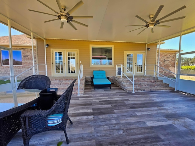 sunroom / solarium featuring a healthy amount of sunlight, a ceiling fan, and french doors