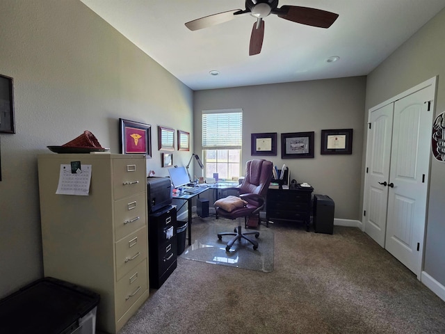 carpeted home office featuring ceiling fan and baseboards