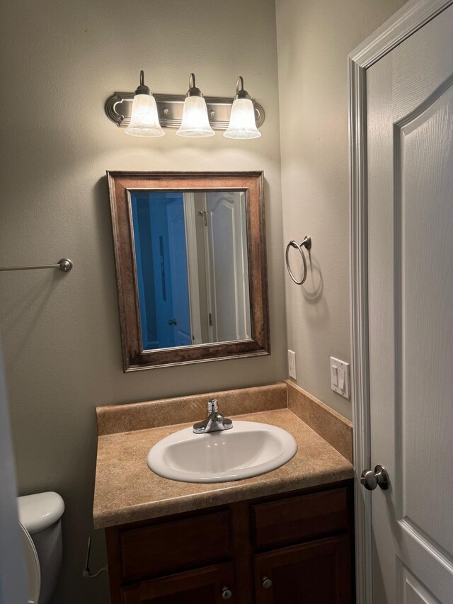 bathroom featuring toilet and vanity