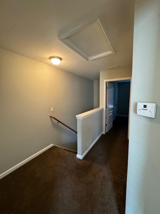 hallway with dark carpet