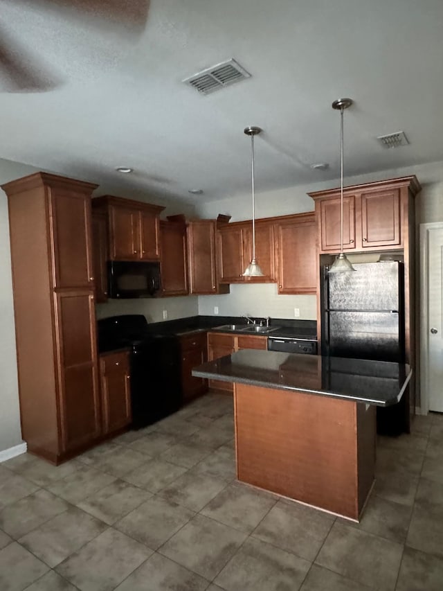 kitchen featuring a kitchen island, sink, hanging light fixtures, and black appliances