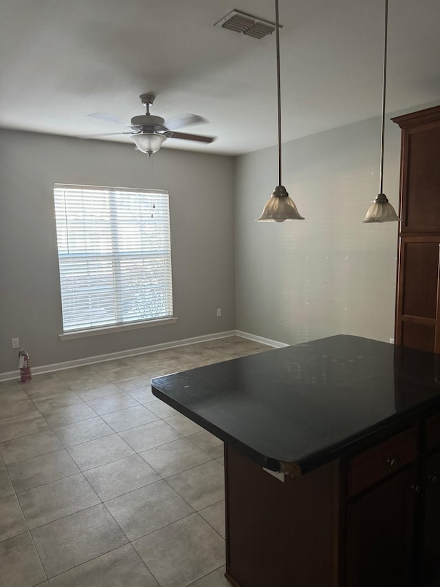 kitchen with pendant lighting, ceiling fan, and light tile patterned floors