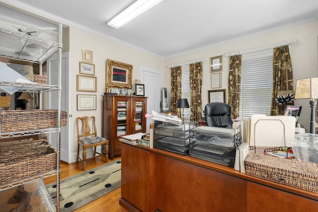 office space with ornamental molding and light hardwood / wood-style floors