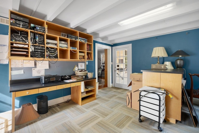 carpeted home office featuring beamed ceiling