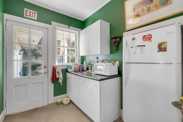 kitchen featuring white cabinetry, sink, and white appliances