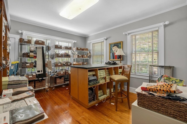 home office with hardwood / wood-style flooring and ornamental molding