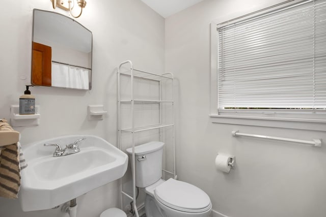 bathroom featuring toilet and sink