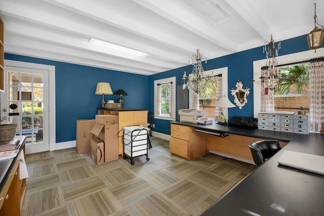 carpeted home office with a chandelier and beam ceiling