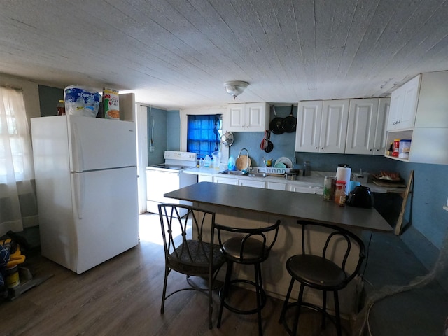 kitchen with white cabinetry, dark wood-type flooring, sink, and white appliances